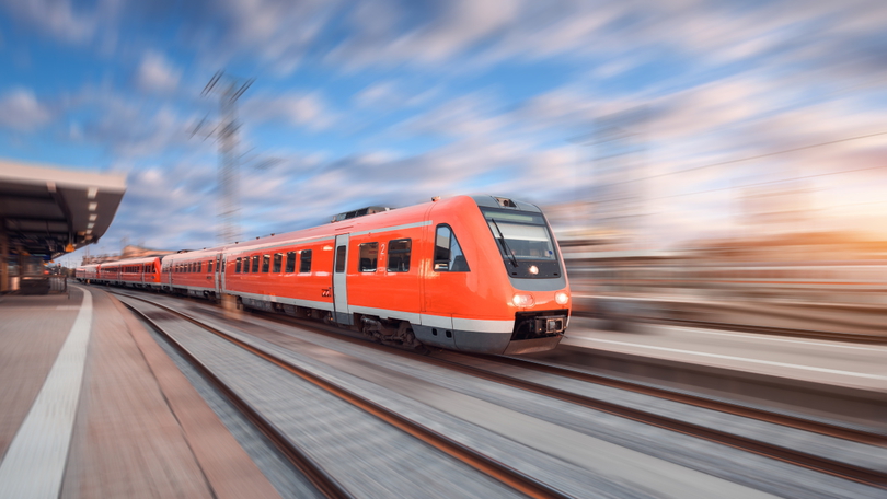 Eine Regionalbahn durchfährt einen Bahnhof. Am linken Bildrand ist ein leerer Bahnsteig zu sehen. Der Fokus liegt auf dem Zug selbst. Der Rest des Bildes ist unscharf und deutet dadurch die Geschwindigkeit der Regionalbahn an. Eine Regionalbahn durchfährt einen Bahnhof. Am linken Bildrand ist ein leerer Bahnsteig zu sehen. Der Fokus liegt auf dem Zug selbst. Der Rest des Bildes ist unscharf und deutet dadurch die Geschwindigkeit der Regionalbahn an.