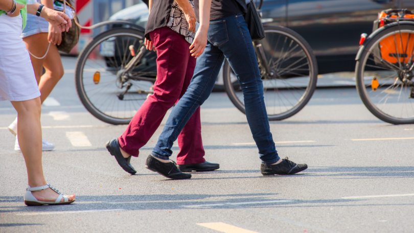 Mehrere Fußgänger überqueren eine Straße Mehrere Fußgänger überqueren eine Straße